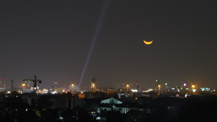 Moon set in city.