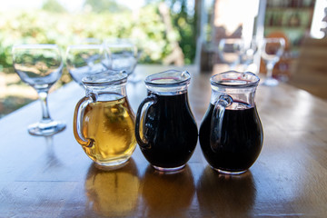 Three different wines in jugs