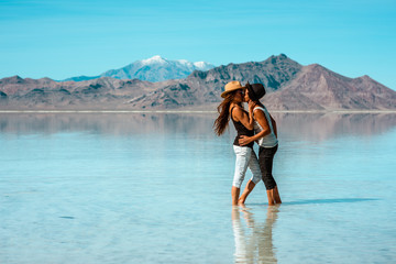 Couple kissing near water in the summer