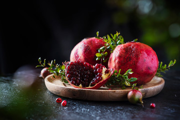 Sweet red pomegranate with green leaves