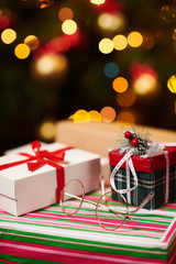Close-up of gift boxes. Christmas lights and decoration on dark background - Happy Holidays concept