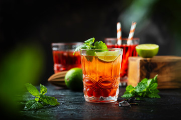 Red fresh cocktail with ice and lime