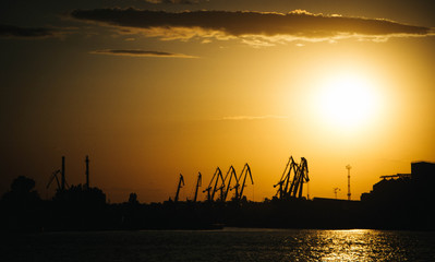 
Silhouetted seaport at sunset