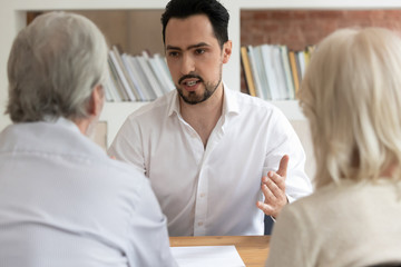 Male consultant speak helping mature client couple with loan