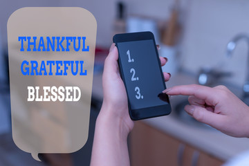 Writing note showing Thankful Grateful Blessed. Business concept for Appreciation gratitude good mood attitude woman using smartphone and technological devices inside the home
