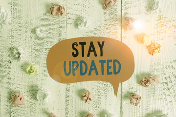 Conceptual hand writing showing Stay Updated. Concept meaning keep modern recent or containing the latest information Colored speech bubble paper balls wooden rustic vintage background
