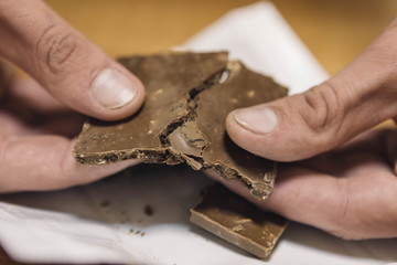 Breaking chocolate bar on pieces
