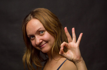 Obraz premium Portrait of young woman, no make up, low key, brown dark hair, no retouch making expressions