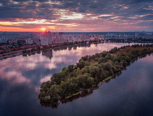 Beautiful aerial view of Obolonska quay in Kyiv, Ukraine; colorful reflection on the water of...