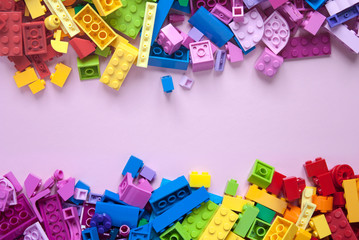 Colorful toy bricks frame with pink empty space for your content