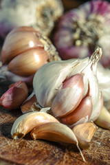 Organic garlic,Closeup garlic on wooden texture on for cooking on dark background, concept healthy lifestyle.Fresh peeled garlics and bulbs.