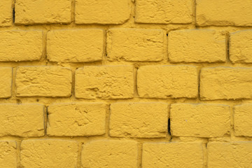 Fototapeta premium Yellow brick plastered wall for background.