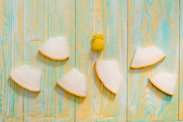 Sliced melon on blue and yellow wooden old background. Summer exotic fruits.Flat lay, top view.