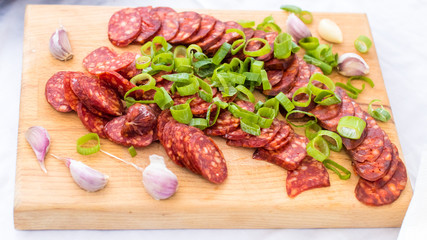 Hungarian spicy sausage sliced on a cutting board