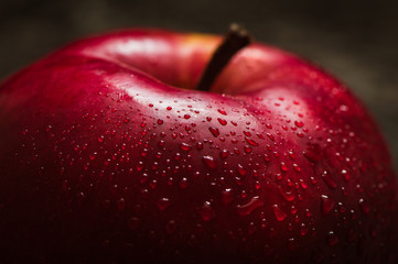 Apple red. Close-up of an apple. Water spray droplets. © sharshonm