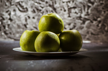 Green fresh apples on the table, cut.