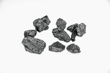 Pieces black coal lie on white isolated background, copy space
