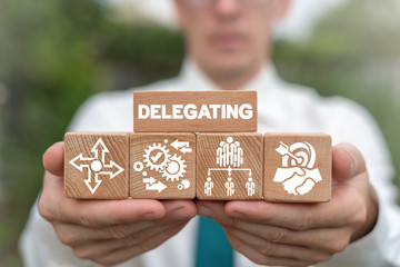 Delegating Leadership Business Organization Concept. Leader arranging wooden blocks with delegate...