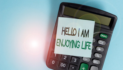 Text sign showing Hello I Am Enjoying Life. Business photo showcasing Happy relaxed lifestyle Enjoy simple things Portable electronic calculator device blank sticky note colored background