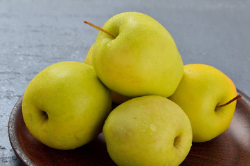 Fresh yellow apples. Wash apples in water.