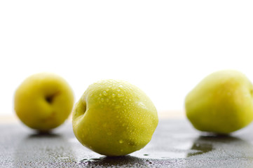 Green fresh apples on the table, cut.