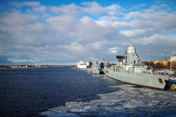 NATO warships in the city port in Riga, Daugava river landscape with blue sky and white clouds on the winter day and military grey vessel © Romo Lomo