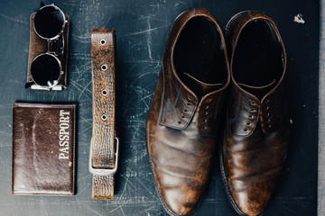 leather accessories shoes, passport glasses. The concept of things on a journey.
