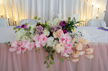 Romantic dinner table prepared for newlyweds. Flowers