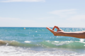 Yoga teacher doing some yoga exercises by the beach. Morning routine.