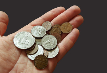 Pile of coins sitting in a hand