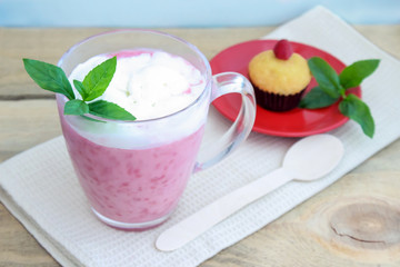 Raspberry smoothie with mint and muffin.