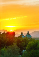Two church towers over beautiful sunset in the mountains. © Sylwia