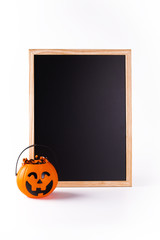 Halloween blackboard and pumpkin full of candies