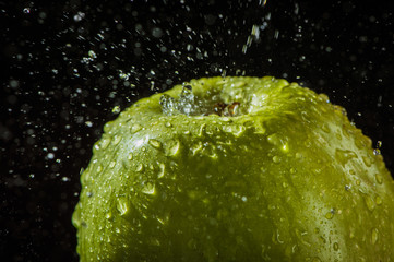 Apples in water, drops, splashes.