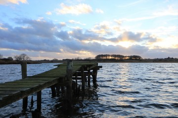 wooden jetty with scenic lake view