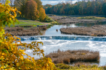 View of the Rumba waterfall in autumn in the city of Kuldiga in Latvia.