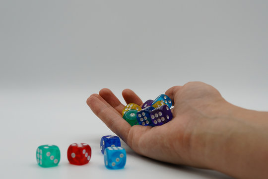 Chaos in the universe, logic thinking and human brain. Woman's hand throwing game cubes on white background and mixing them chaotically. Shaking hand with square cubes in 4K - Powered by Adobe