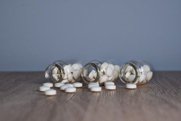 bottle of tablets on wooden surface