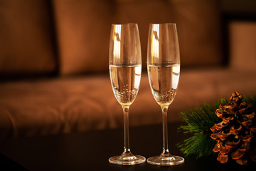 Glasses filled with champagne on Christmas background