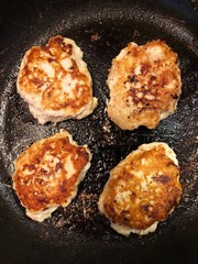 Chicken cutlets in a frying pan close up