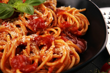 Plate of delicious spaghetti Bolognaise or Bolognese with savory minced beef and tomato sauce garnished with parmesan