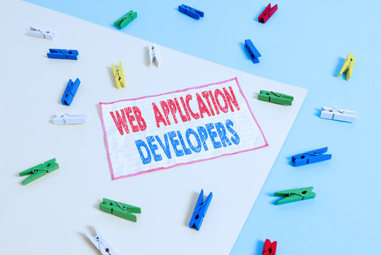 Conceptual hand writing showing Web Application Developers. Concept meaning Internet programming experts Technology software Colored clothespin paper reminder with yellow blue background