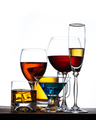 assortment of alcoholic beverages and glasses