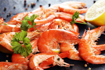 Raw fresh Prawns Langostino Austral. shrimp seafood with lemon and spices on dark
