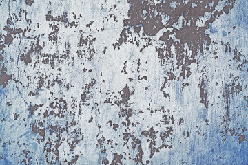 Old shabby concrete wall with peeled faded paint. Background and texture. Close-up, copy space