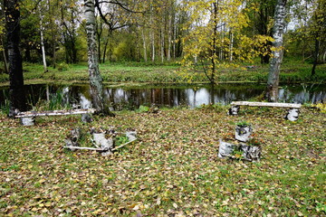 Autumn landscape with pond and trees changing color in October
