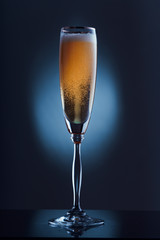glass of champagne in the dark
