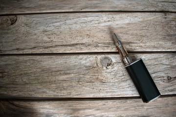 Vape devices on wooden background