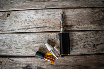 Vape devices on wooden background