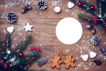 Christmas card with stars,fir and fir-cone on wooden background